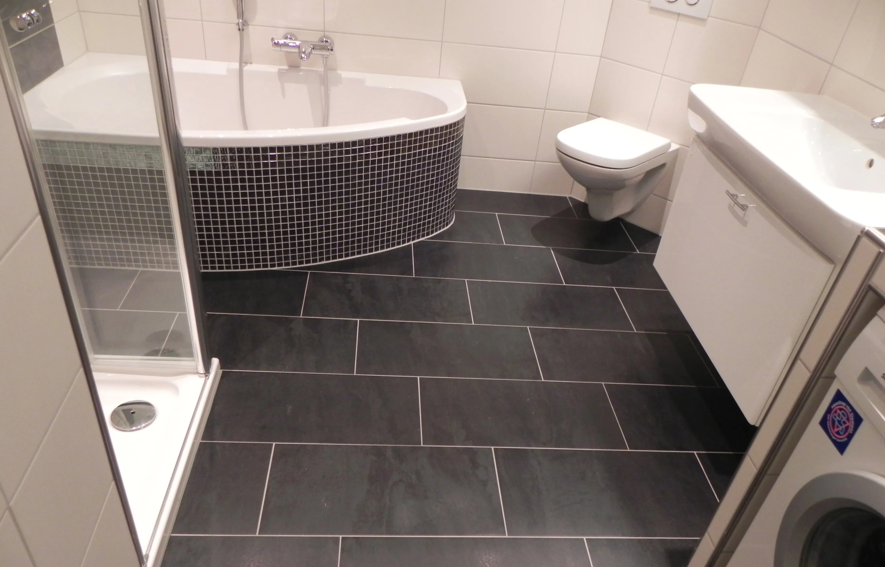 Hochwertig gefliestes Badezimmer mit großformatigen Platten und feiner Fugenoptik